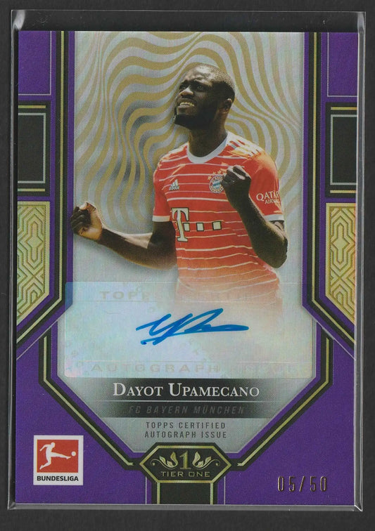 Purple and gold bordered trading card featuring a red bayern munich jersey with dayot upamecano signature 05/50